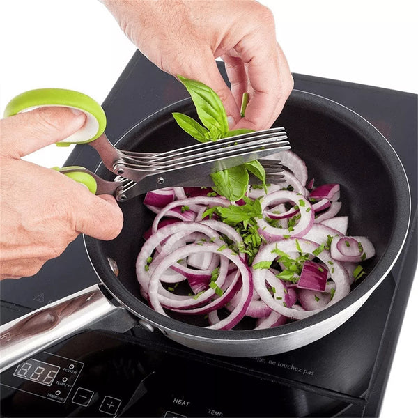 Person using five blade herb scissors cutting vegetables